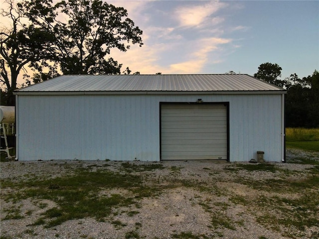 view of garage at dusk