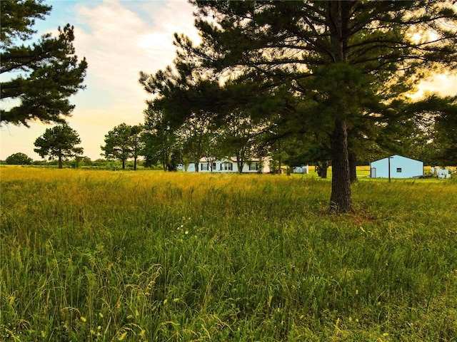 nature at dusk featuring a rural view