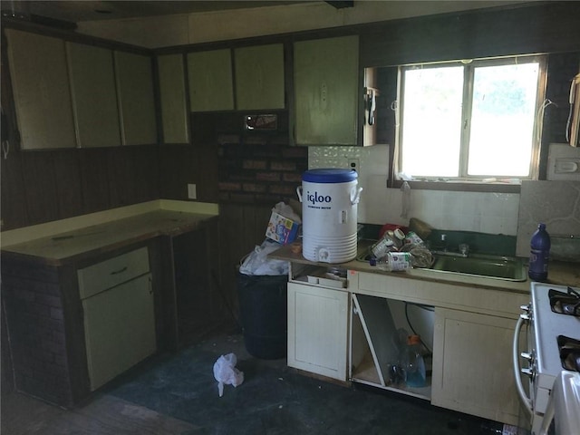 kitchen featuring sink, backsplash, and white stove