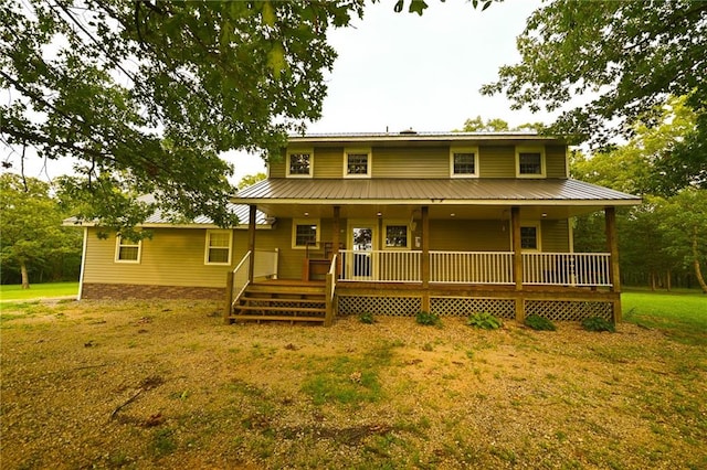 rear view of house featuring a yard