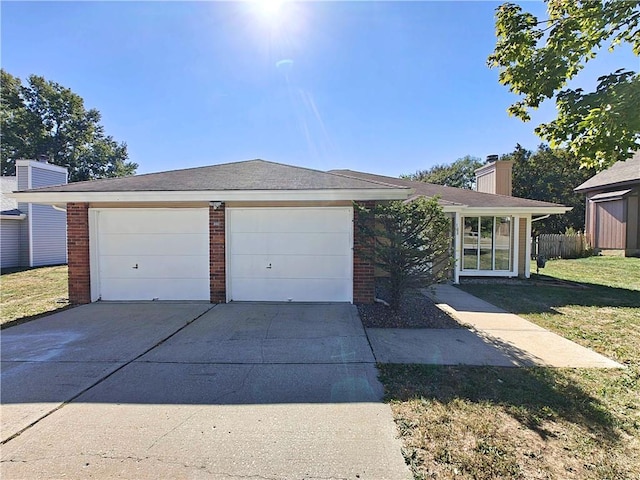 view of front facade with a front yard and a garage