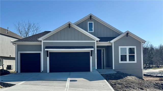 view of front of property featuring board and batten siding, concrete driveway, roof with shingles, and an attached garage