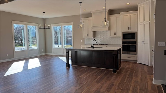 kitchen featuring dark wood-style floors, light countertops, backsplash, stainless steel oven, and built in microwave