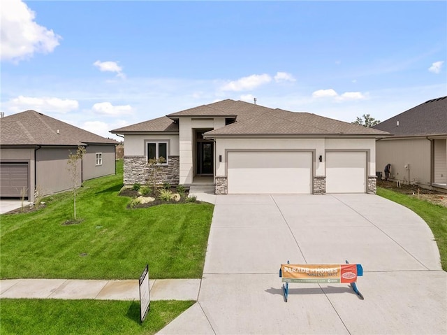 prairie-style home with a front yard and a garage