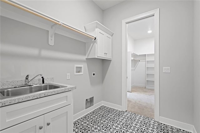 laundry room with hookup for a washing machine, sink, hookup for an electric dryer, and cabinets