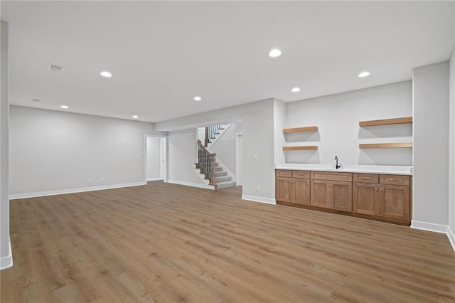 interior space with sink and light hardwood / wood-style flooring