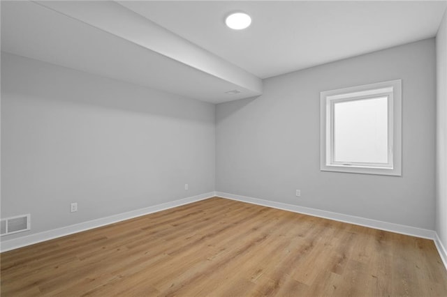 unfurnished room with light wood-type flooring