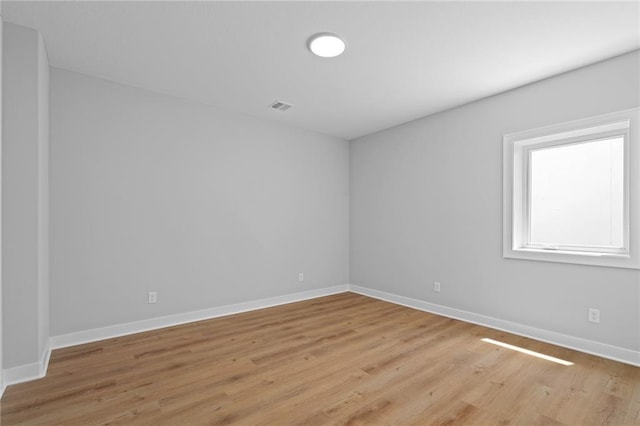 spare room featuring light wood-type flooring