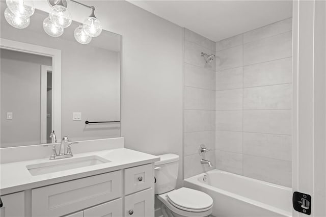 full bathroom with toilet, vanity, and tiled shower / bath combo