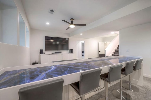 carpeted home theater featuring ceiling fan