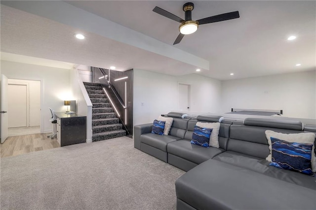 home theater featuring ceiling fan and light colored carpet