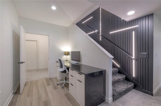 office area with vaulted ceiling and light hardwood / wood-style floors