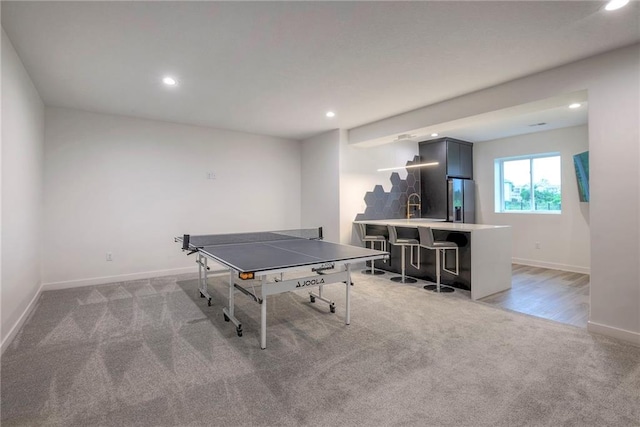 game room featuring sink and light carpet