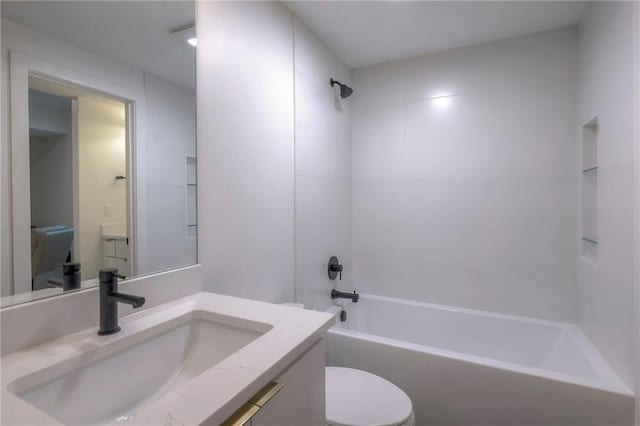 full bathroom with vanity, toilet, and tiled shower / bath combo