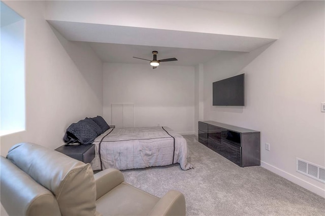 carpeted bedroom featuring ceiling fan and a fireplace