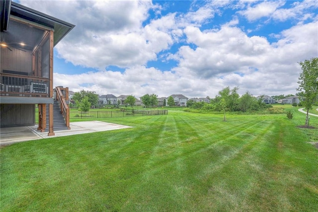 view of yard featuring a sunroom and a patio area