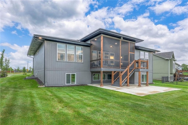 back of house featuring a patio, a sunroom, and a yard