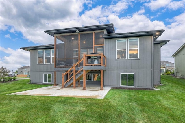 rear view of house featuring a sunroom, a yard, and a patio