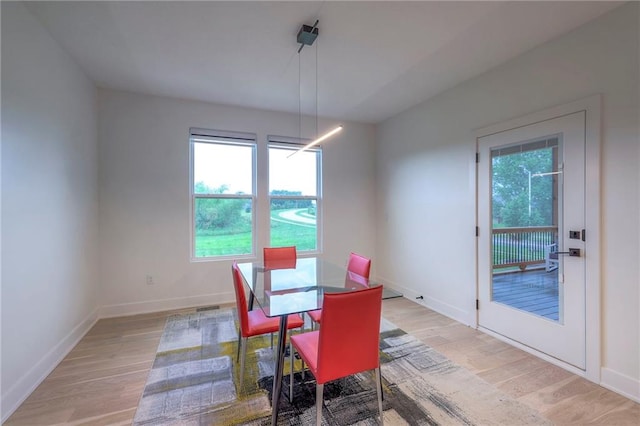 dining space featuring light wood-type flooring