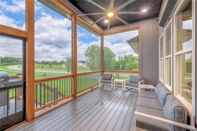 sunroom featuring beam ceiling