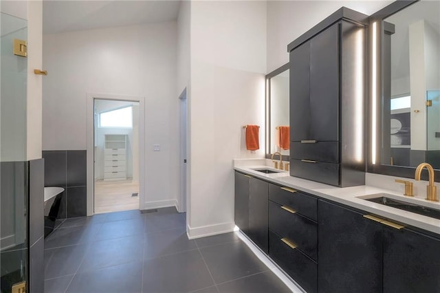 bathroom featuring vanity, tile patterned floors, and a high ceiling