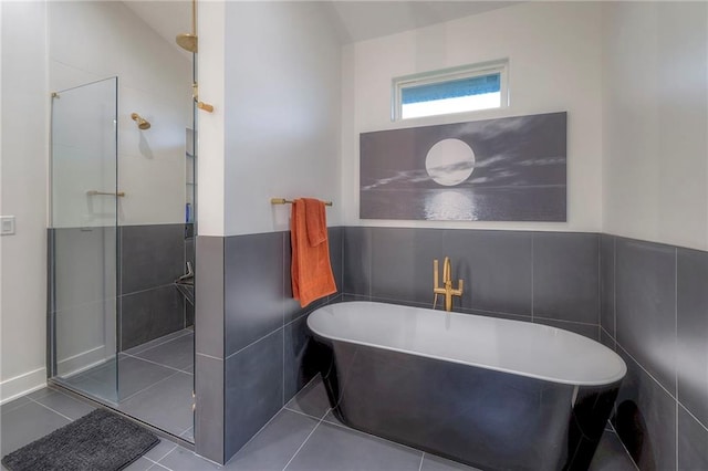 bathroom with separate shower and tub, tile walls, and tile patterned floors