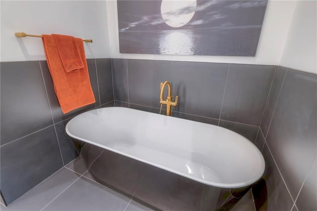 bathroom featuring tile patterned flooring, tiled bath, and tile walls