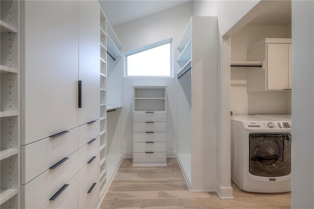 walk in closet featuring washer / dryer and light hardwood / wood-style floors