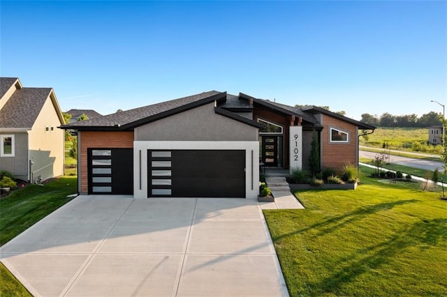 contemporary house with a garage and a front lawn