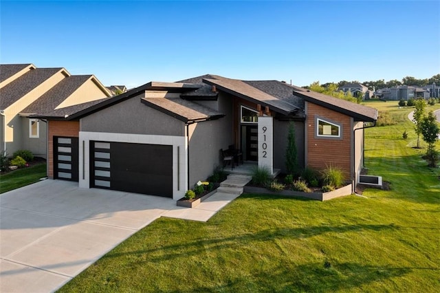 view of front of property featuring a garage and a front yard