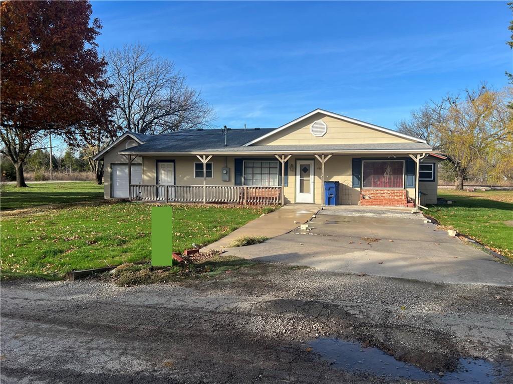 view of front of property with a porch and a front yard