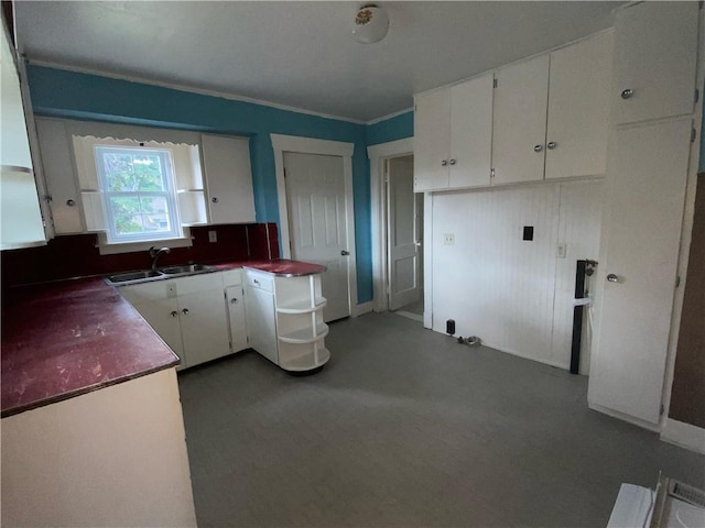 kitchen featuring sink and white cabinetry