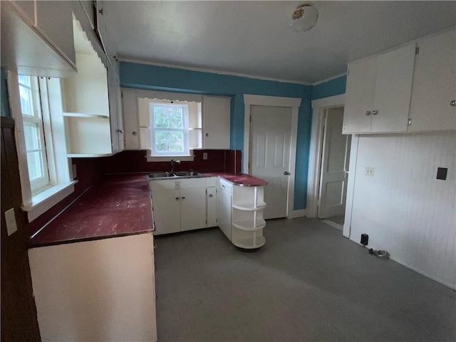 kitchen featuring sink and white cabinetry