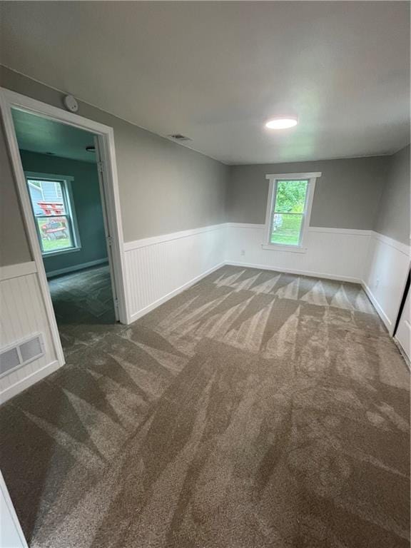 empty room with dark colored carpet