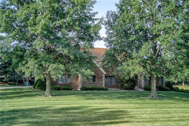 obstructed view of property with a front yard