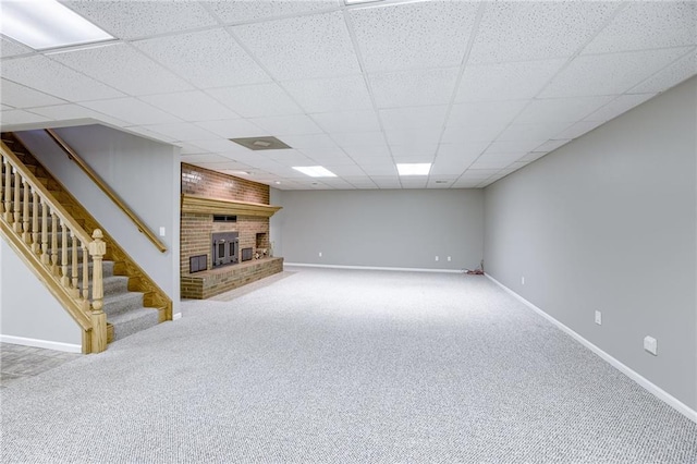 basement with carpet flooring and a paneled ceiling