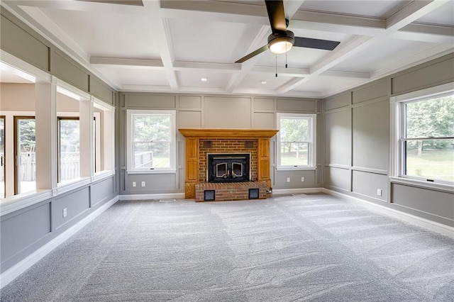 unfurnished living room featuring beam ceiling, ceiling fan, light colored carpet, and coffered ceiling