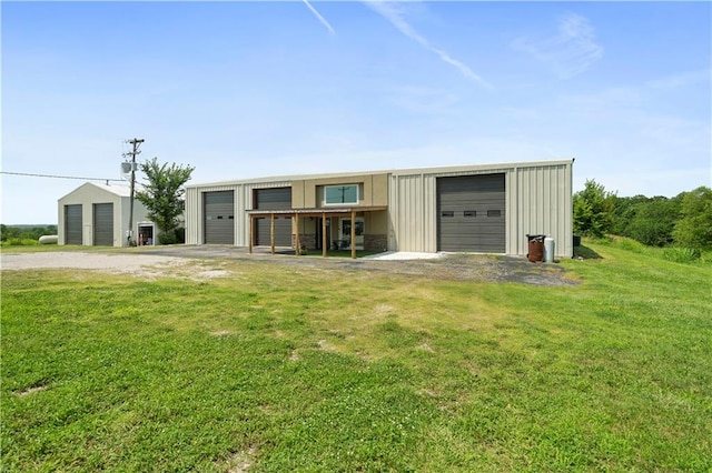 view of front of property with a garage and a front lawn