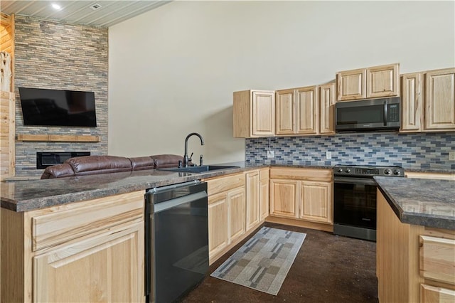 kitchen featuring light brown cabinets, sink, dishwasher, stove, and a stone fireplace