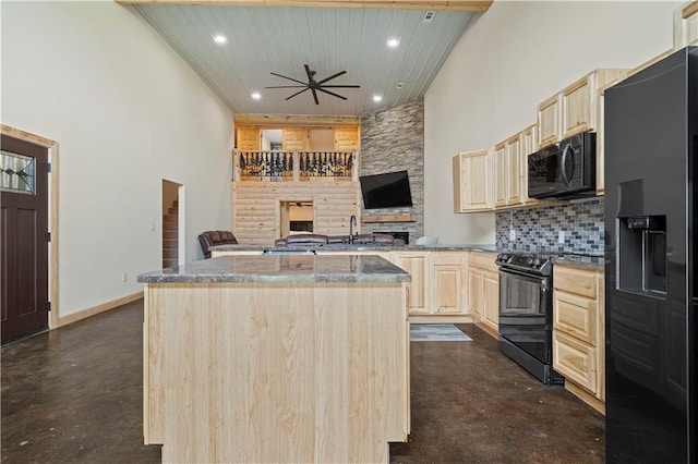 kitchen featuring tasteful backsplash, a kitchen island, black appliances, light brown cabinetry, and sink