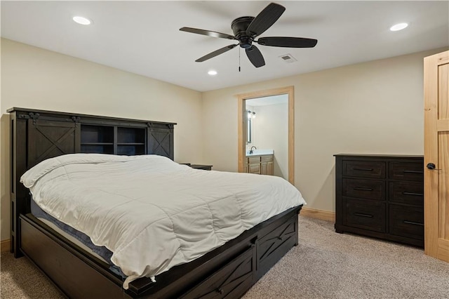 carpeted bedroom featuring ensuite bath and ceiling fan