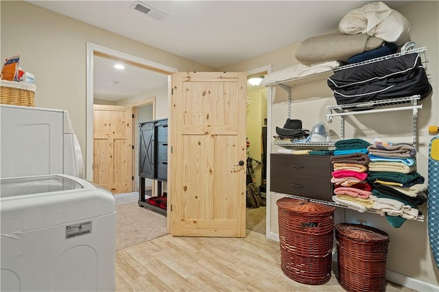 interior space featuring washer / clothes dryer and light carpet