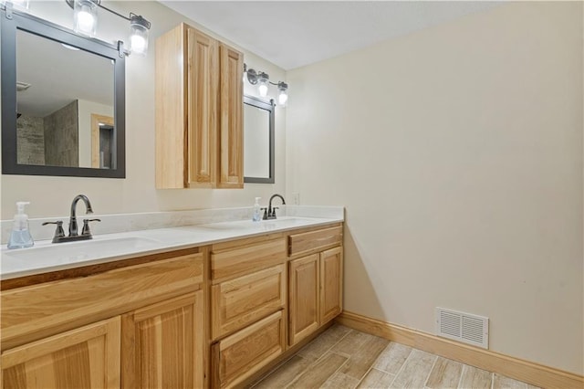 bathroom featuring double vanity and hardwood / wood-style floors