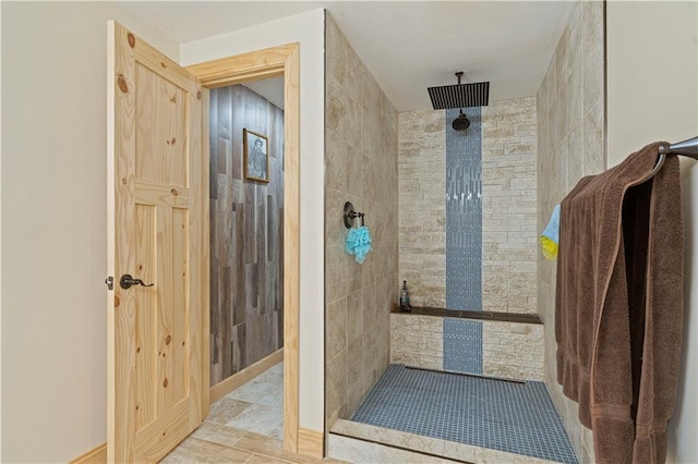 bathroom featuring tiled shower and tile patterned floors