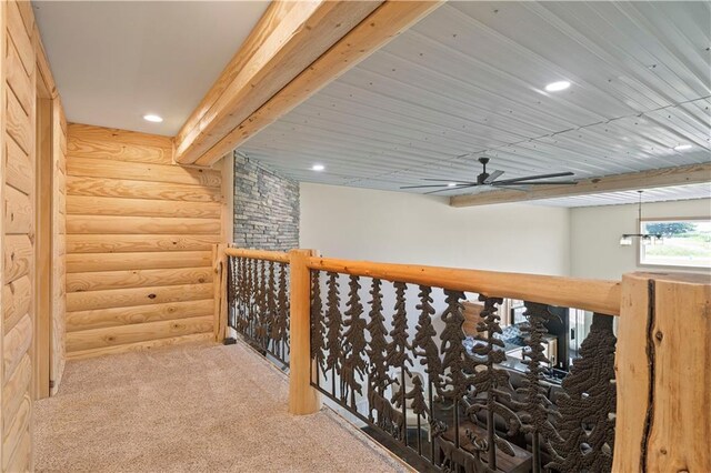 corridor featuring carpet flooring and rustic walls