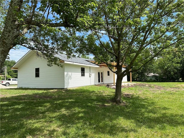 rear view of property with a yard