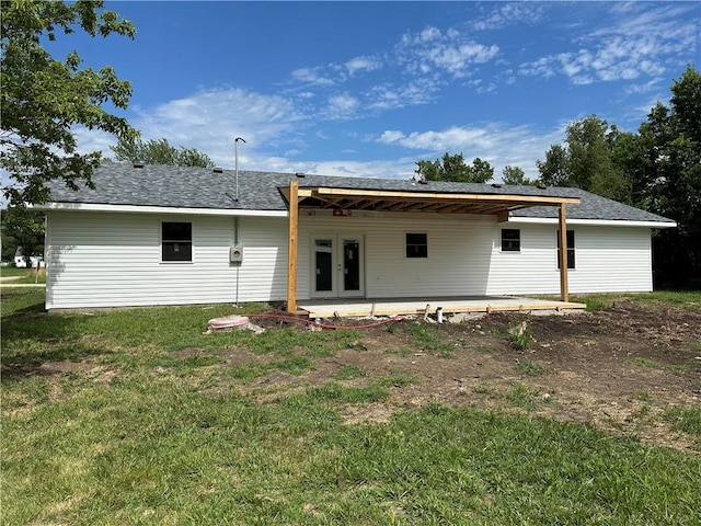 back of house with a yard and a patio