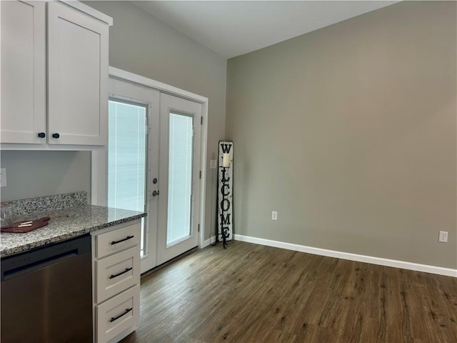 kitchen featuring dark hardwood / wood-style floors, stainless steel dishwasher, white cabinets, and light stone counters