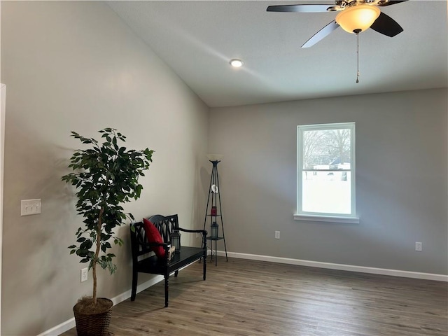 living area featuring wood-type flooring, vaulted ceiling, and ceiling fan