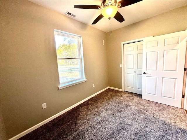 unfurnished bedroom with carpet flooring, ceiling fan, and a closet